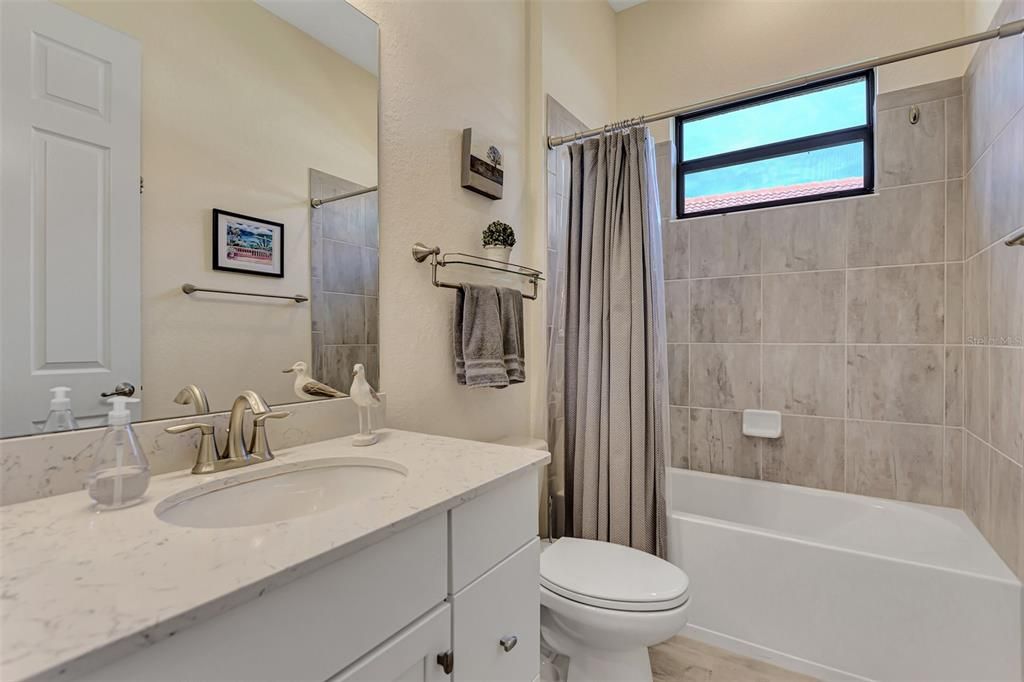 The guest bathroom has a tub/shower combination