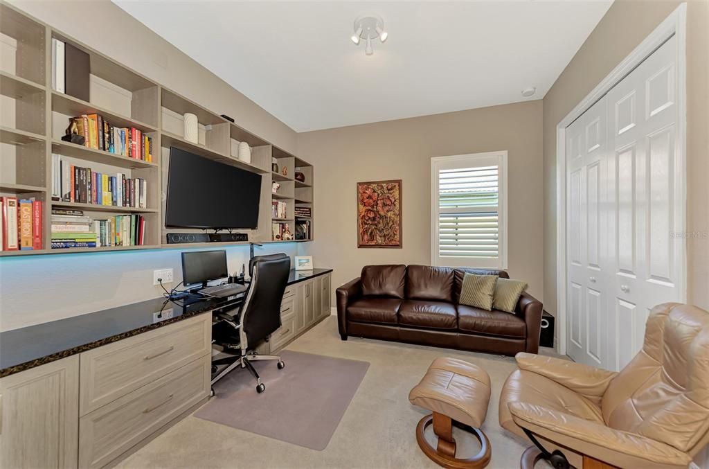 An all time favorite, the second bedroom has a wall of storage and shelving with a queen sleeper sofa - a great room to relax in or have as a private domaine.