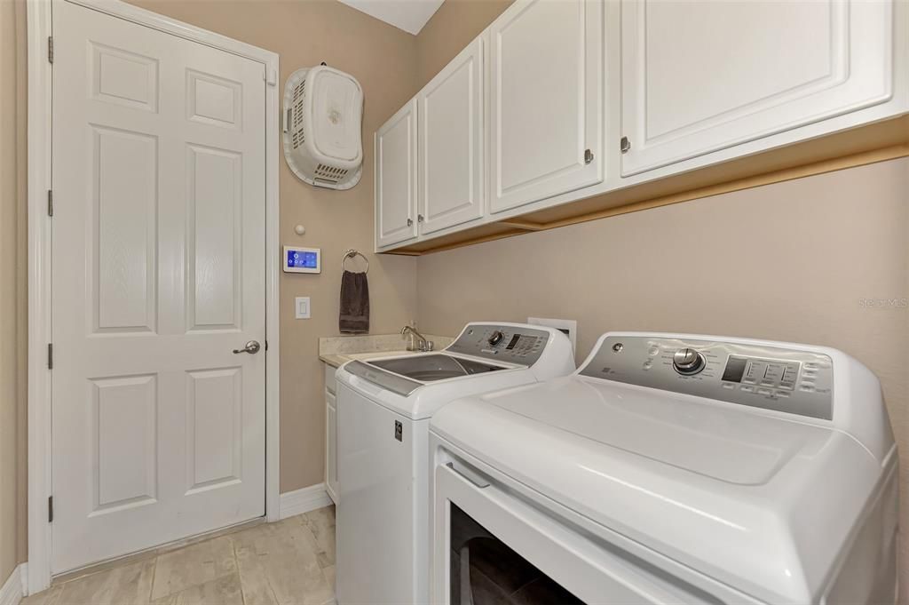 The laundry room is off the garage and features Washer/Dryer and utility tub.