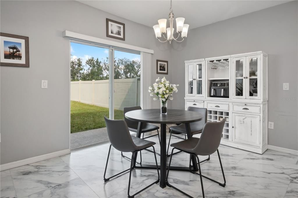 Dinette with fully fenced backyard.