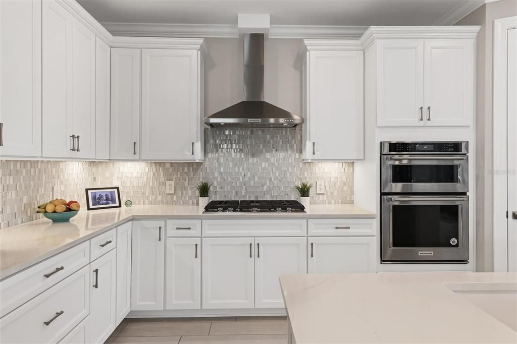 Upgraded gourmet kitchen with built in gas cooktop, stainless vented hood....more.