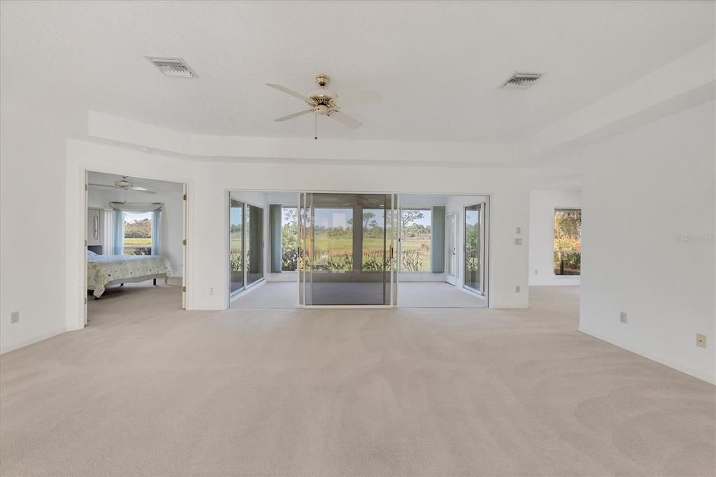 Living room, primary bedroom to the left, Florida room in the center, dining room to the right.