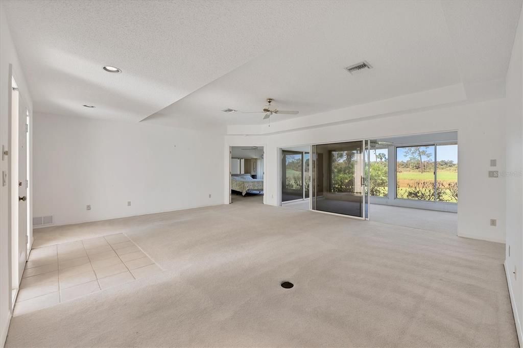 Living room with tray ceiling opens to the Florida room