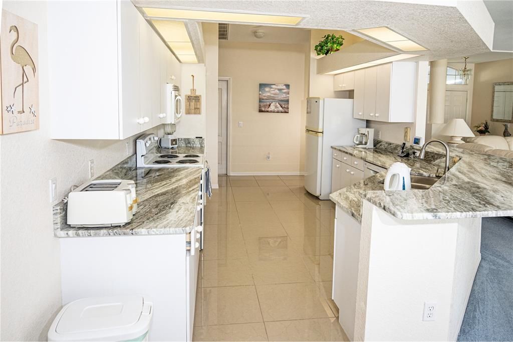 Spacious and open kitchen with new sleek granite counter tops