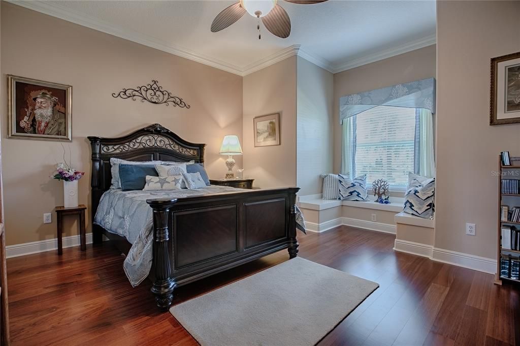 Guest bedroom with large windows and crown molding