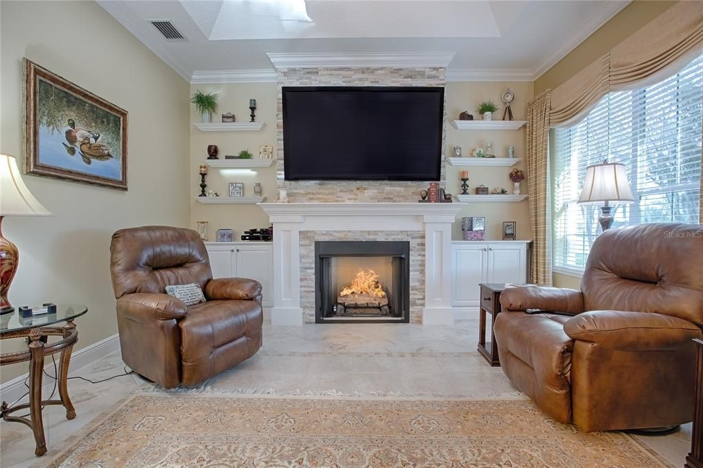 Family room with customer working and fireplace