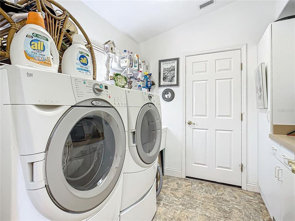 indoor laundry room with sink door to garage