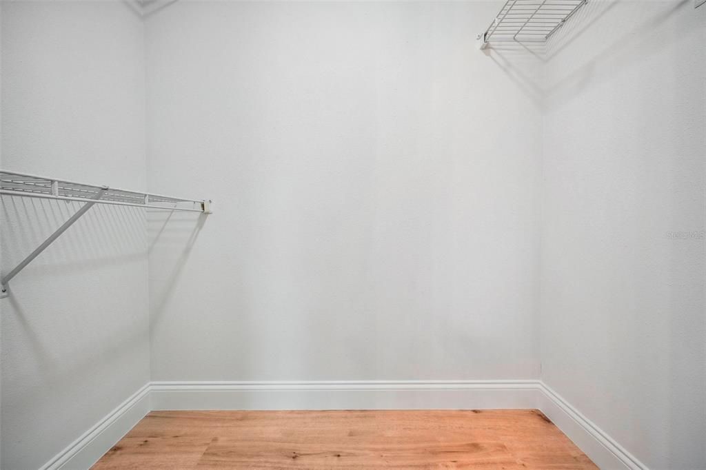 PRIMARY BEDROOM WALK-IN CLOSET.