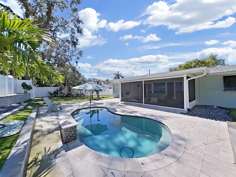 Heated and/or chilled Saltwater pool with waterfall! Surrounded with beautiful travertine tile