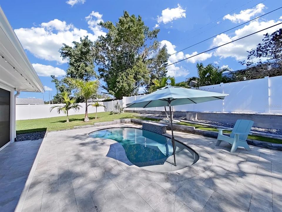 Heated and/or chilled Saltwater pool with waterfall! Surrounded with beautiful travertine tile