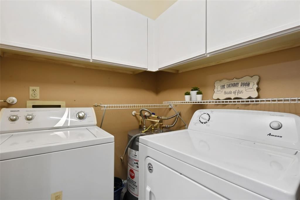 Large pantry/walk in laundry room off kitchen complete with storage cabinets.