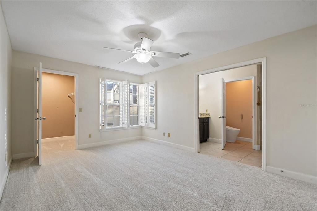 Primary bedroom on main level overlooks private courtyard.