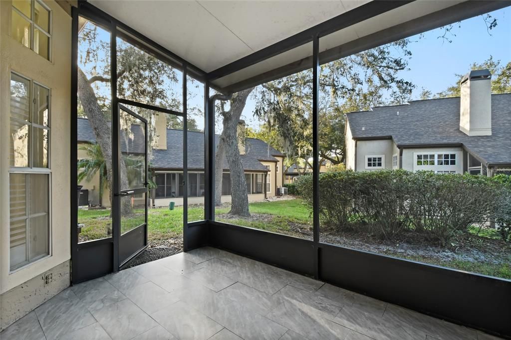 Inside the covered, screened porch which is tiled and ready for your outdoor leisure.