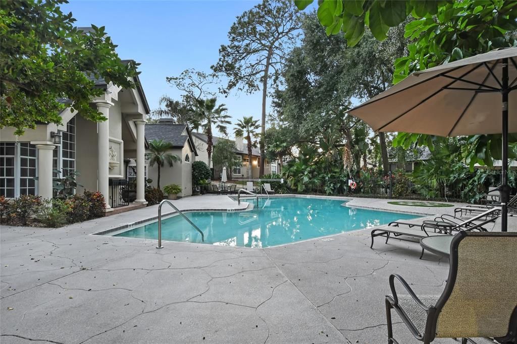 Community pool and lounge chairs for relaxing in true Florida lifestyle