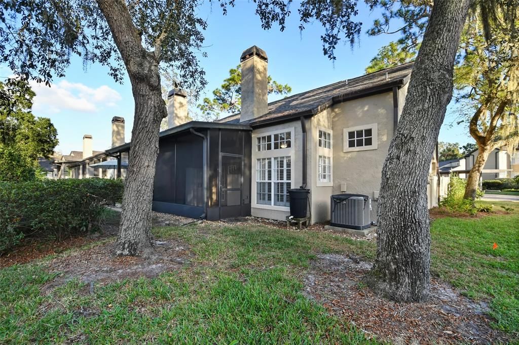 A great view of rear screened porch and the green space to the right of unit provides privacy.