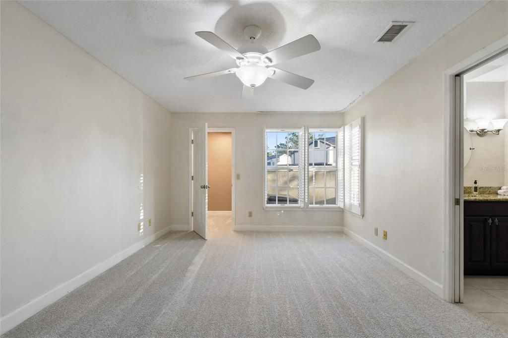 Brand new carpeting, ceiling fan and plantation shutters are features of this first floor bedroom