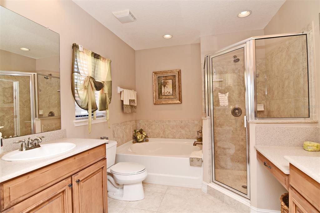 Master bath has double vanities, one with lower counter for comfortable seating.