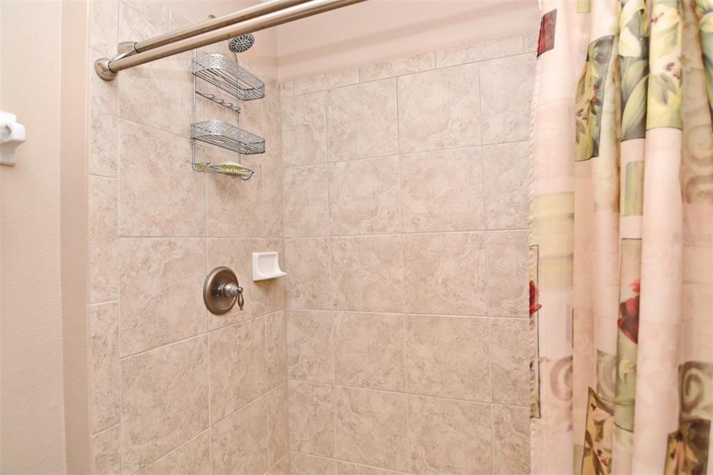 Clean, tiled shower/bath on first floor.