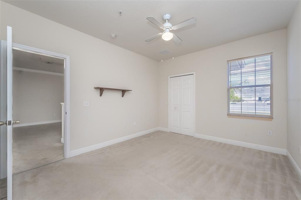 bedroom with walk in closet & ensuite bathroom & linen closet