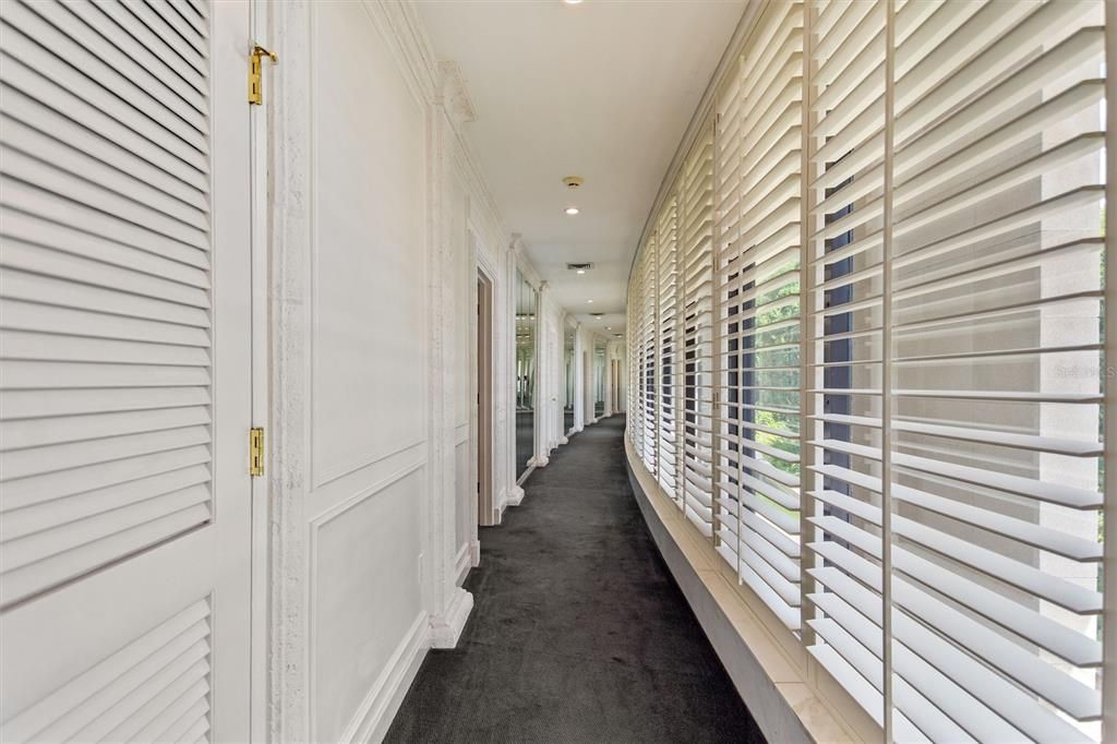 Primary bedroom has Plantation windows all across the front with a view of the moat.