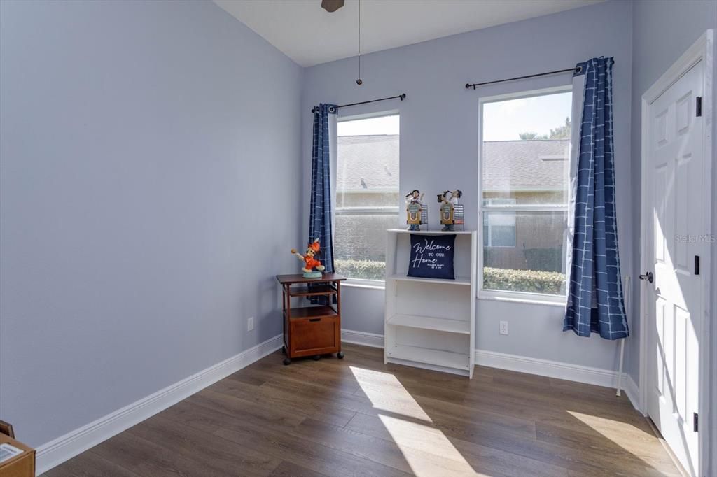 Bedroom 2 with walk in closet and new vinyl wood flooring