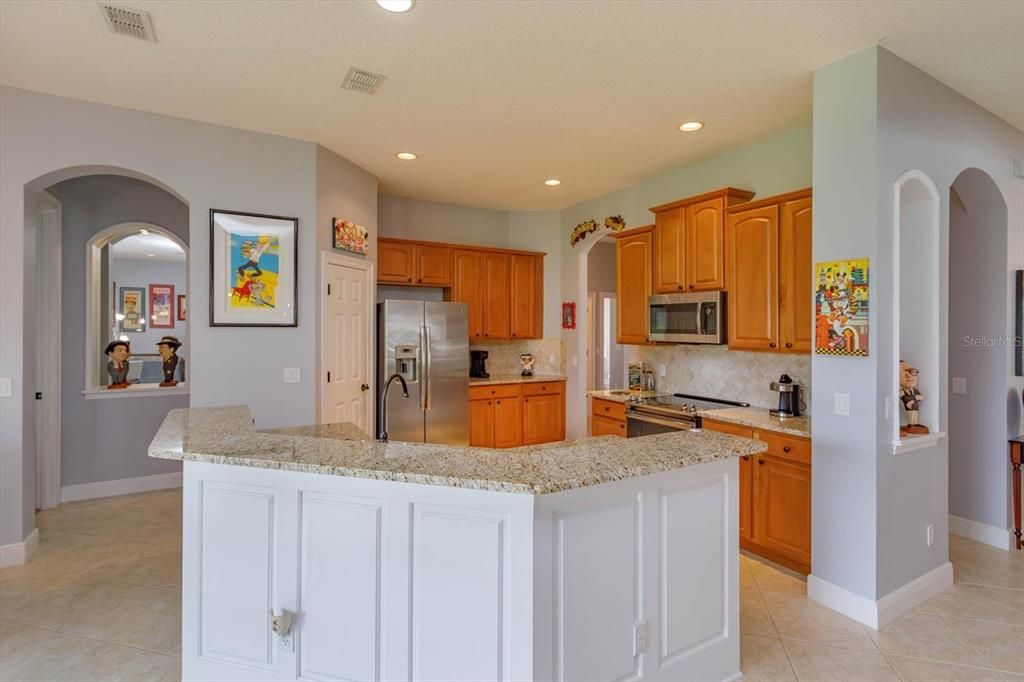 Granite counters with tile backsplash and spacious bartop