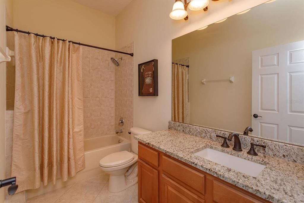 Bathroom 2 with granite counter and tile floors