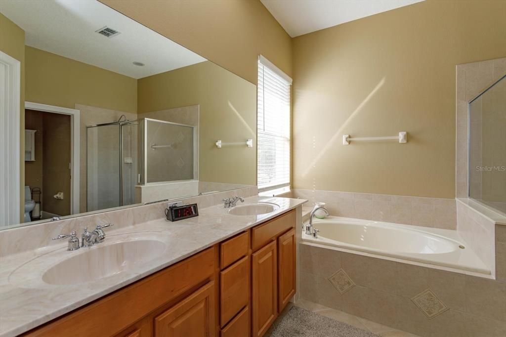 Dual sink cultured marble vanity in the primary bathroom