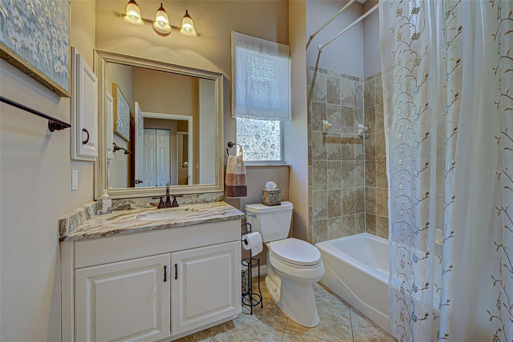 2nd bathroom has newly installed granite countertops and bathtub with lovely tile.