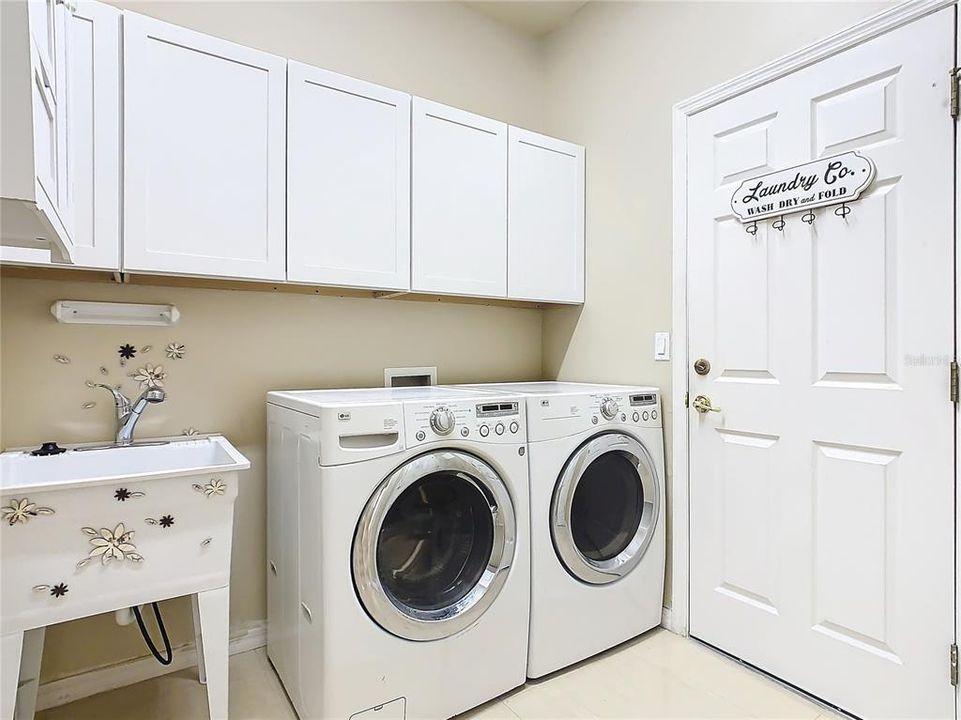 INSIDE LAUNDRY ROOM WITH CABINETS