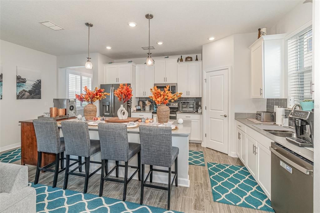 Quartz Countertops, Stainless Appliances, Custom Shelving in Pantry