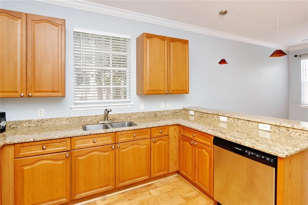 Kitchen with breakfast bar and pendant lights