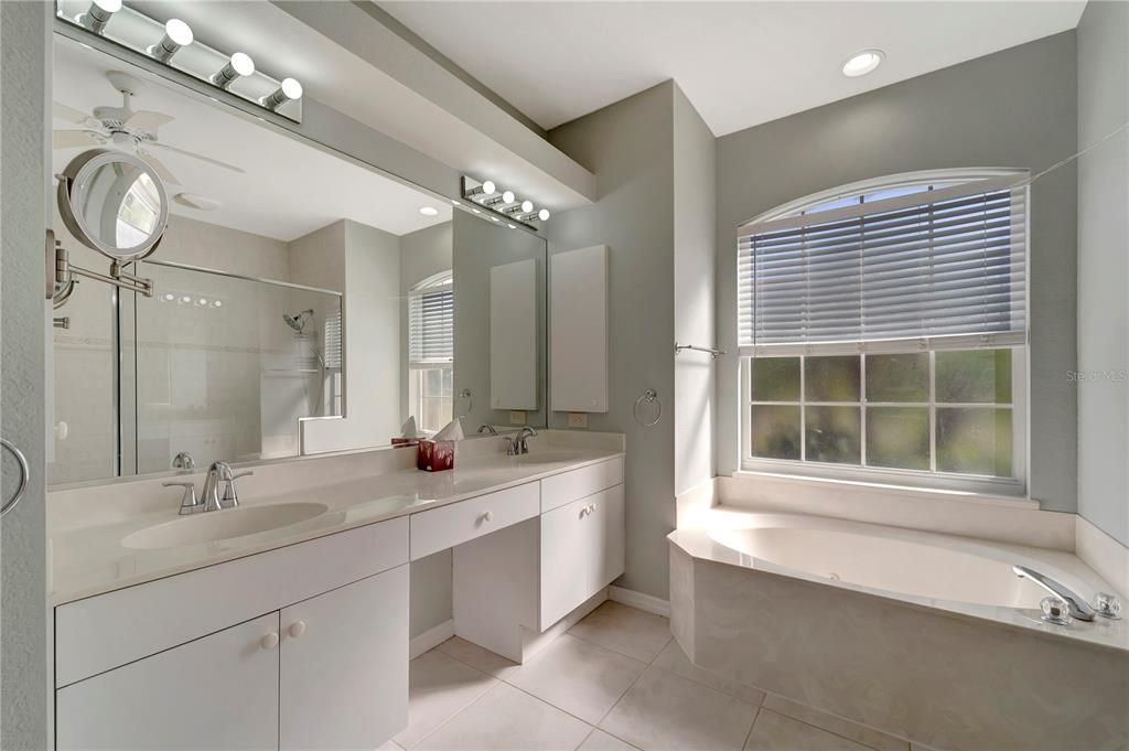 En-Suite Primary Bath with raised double sink vanity, linen closet and Water Closet