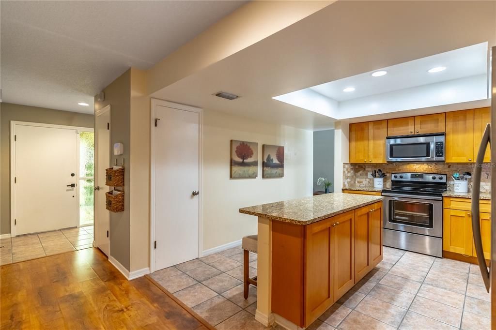 Foyer to the kitchen, pantry and island with extra storage