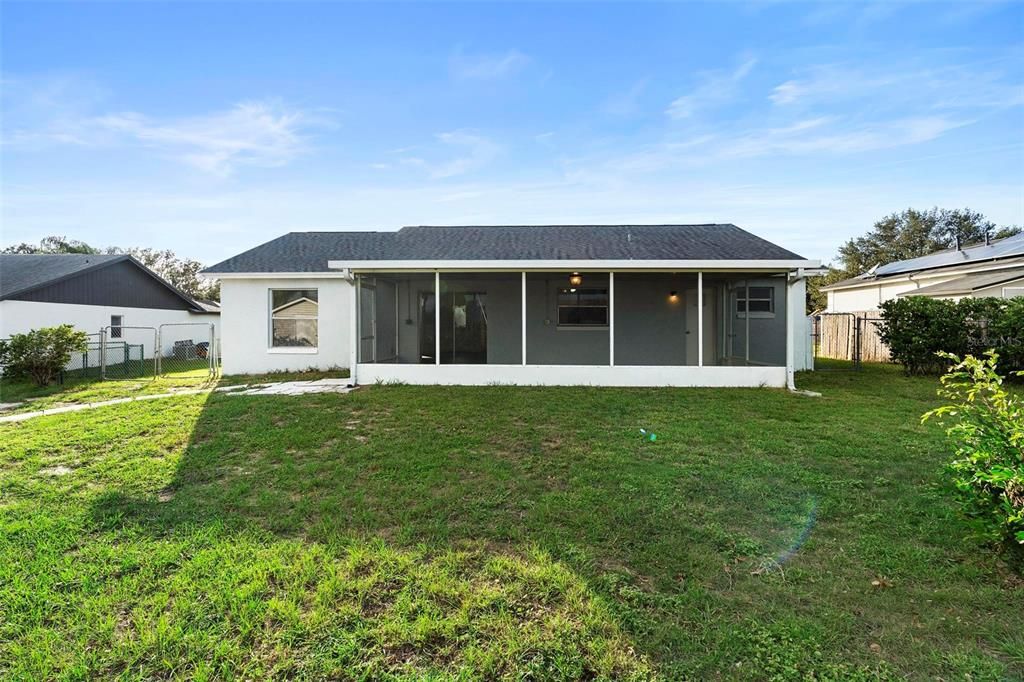 rear view/ large fenced yard