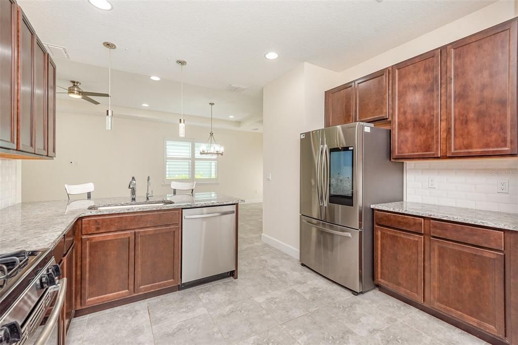 Granite counters, stainless steel appliances, under mount sink & spacious cabinetry