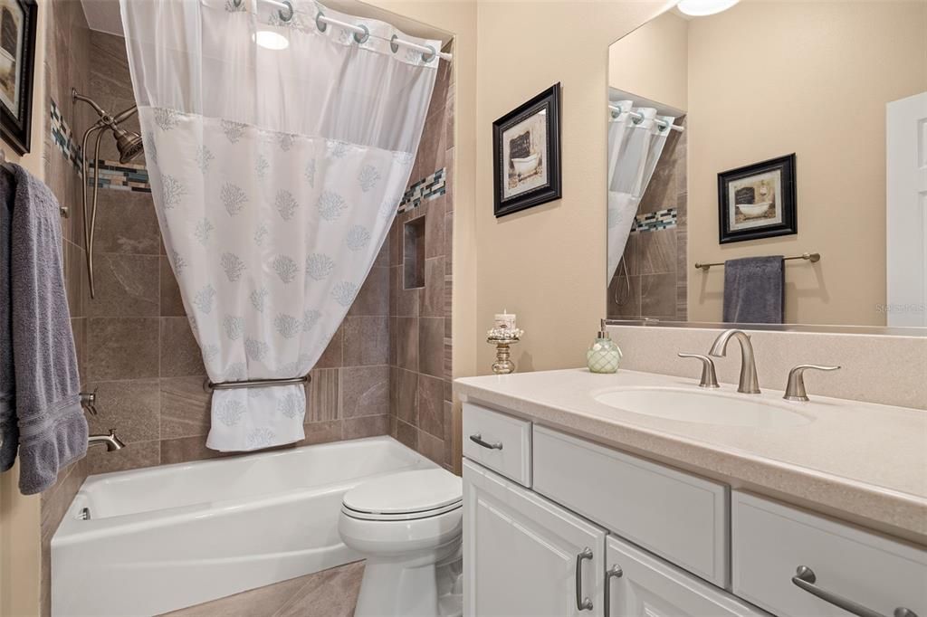 The guest bathroom with a tub/shower combo is ideally located for your guest's convenience.