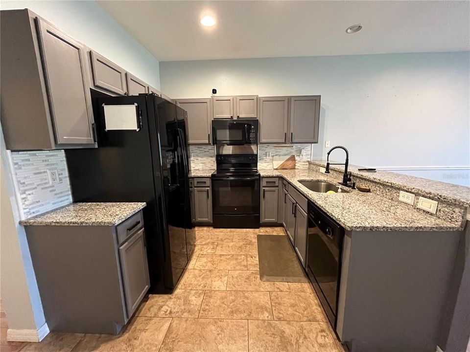 Stylish kitchen with black appliances