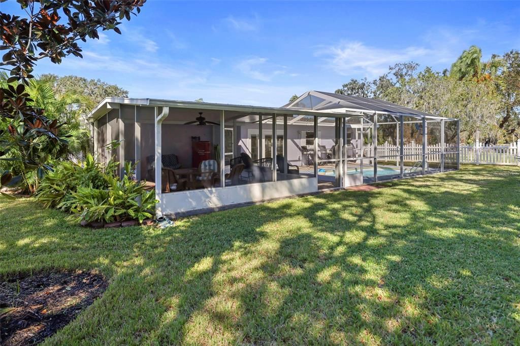 Backyard completely fenced with mature plantings