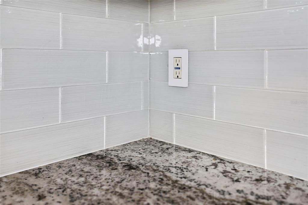 Granite Counters with bright glass backsplash