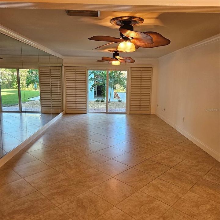 Living Room with 2 Ceiling Fans and Sliders to the Patio