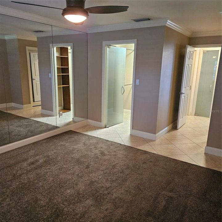 Bedroom with view of walk-in closet and doorway to hall.