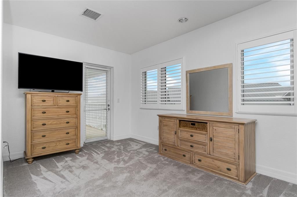 Primary bedroom with exterior patio