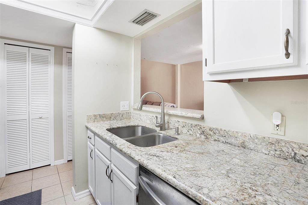 White wood cabinets, stainless steel appliances and new fixtures.