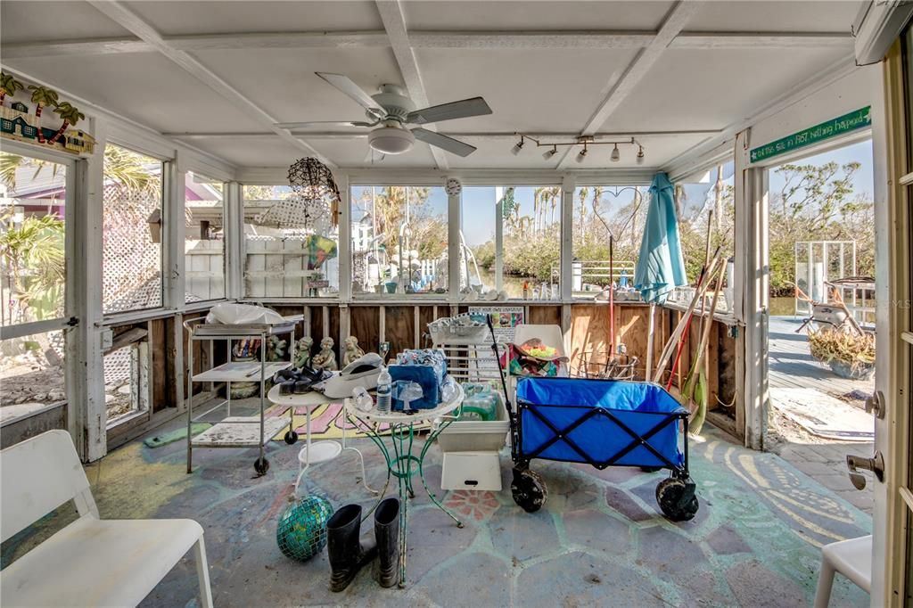 Sunroom with track lighting, coffered ceiling, and ceiling fan