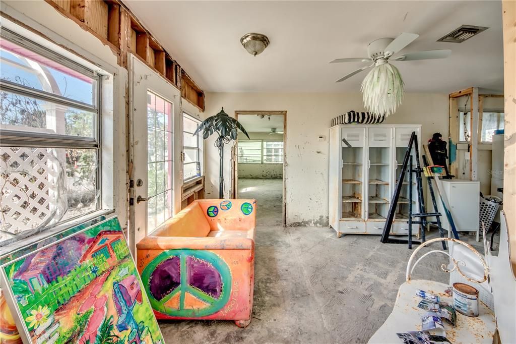 Playroom featuring french doors, ceiling fan, and concrete flooring