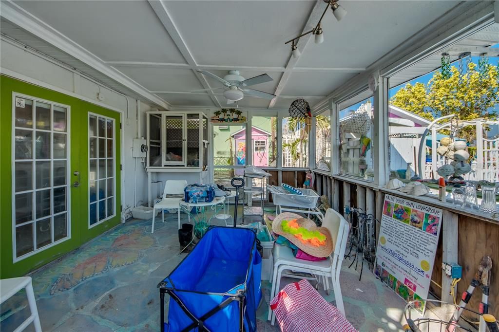 Sunroom with rail lighting, ceiling fan, and french doors