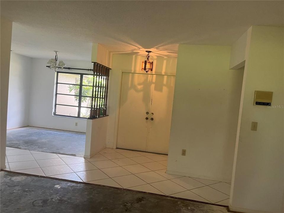 Standing in Liv Rm looking back at entry foyer and Dining room.