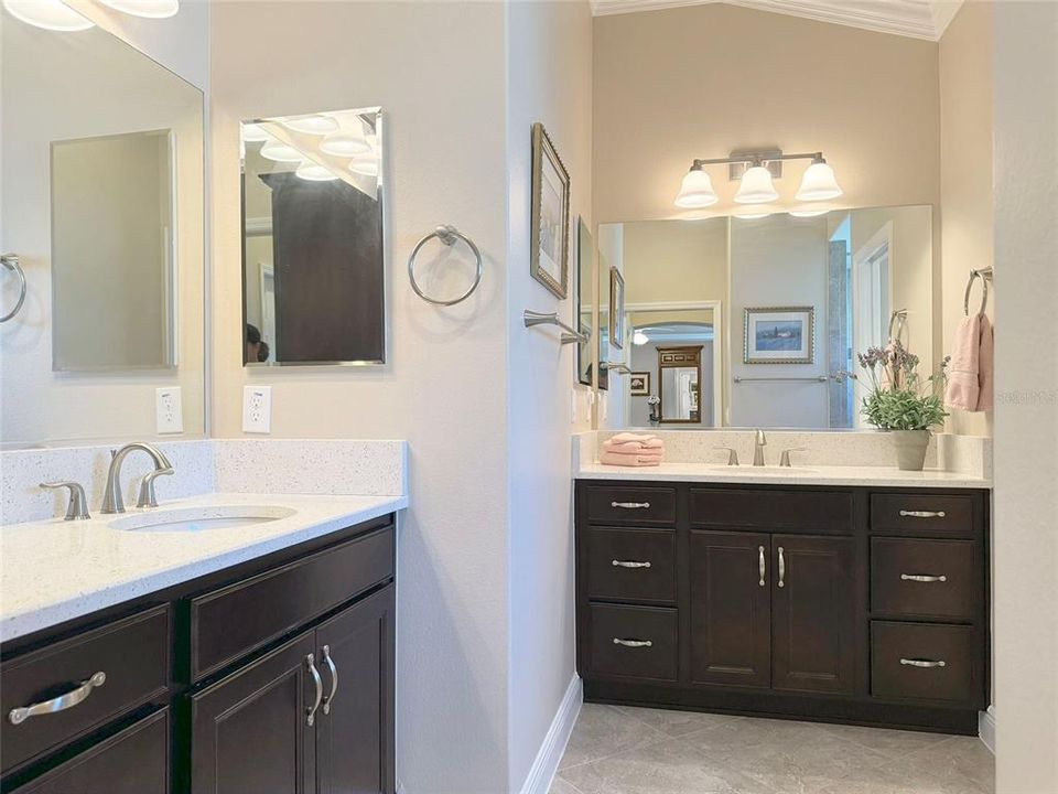 Primary bathroom features split vanities