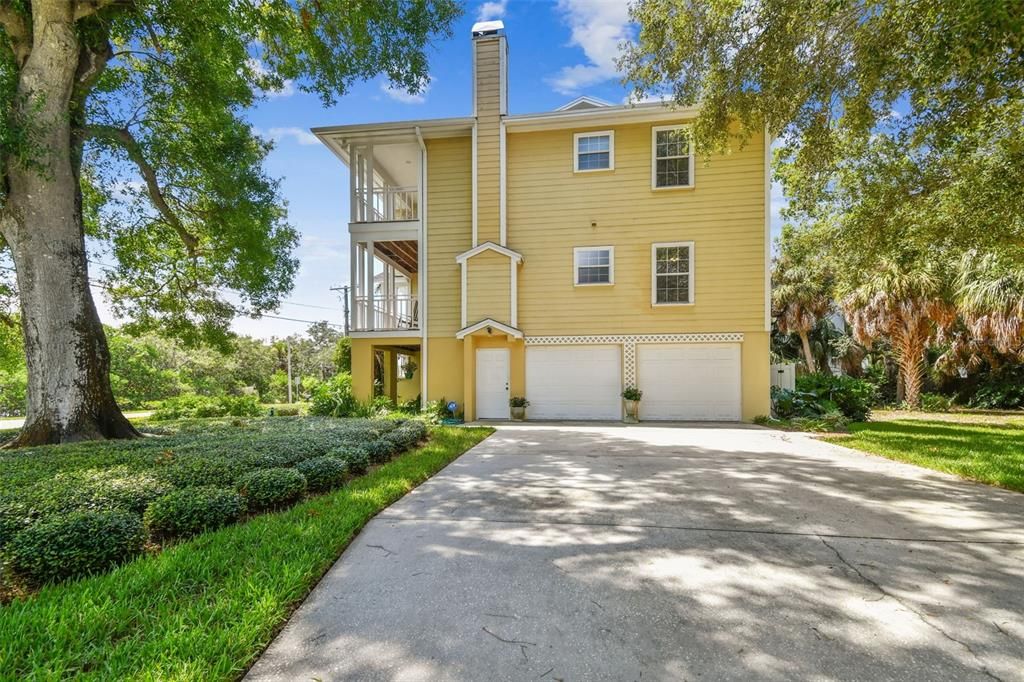 Door and 2 garage doors w/ ample parking on the large driveway